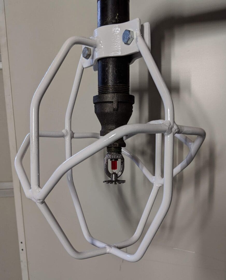 A white metal rack holding a drill and a faucet.