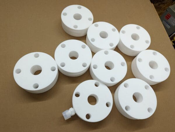 A group of white plastic spacers sitting on top of a table.