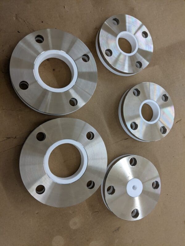 A group of four flanges and one is white.