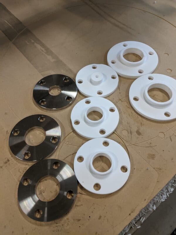 A group of different types of flanges on top of a table.