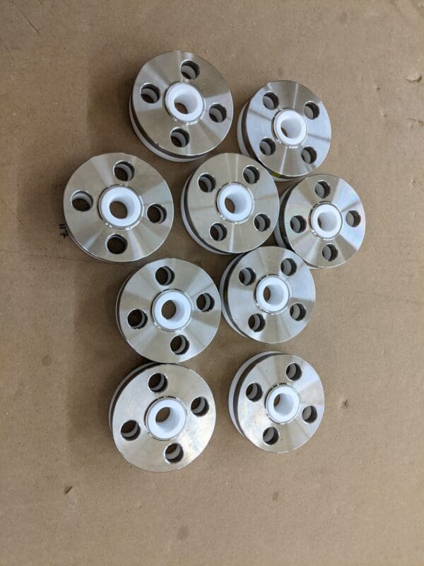 A group of ten metal wheels with white plastic caps.