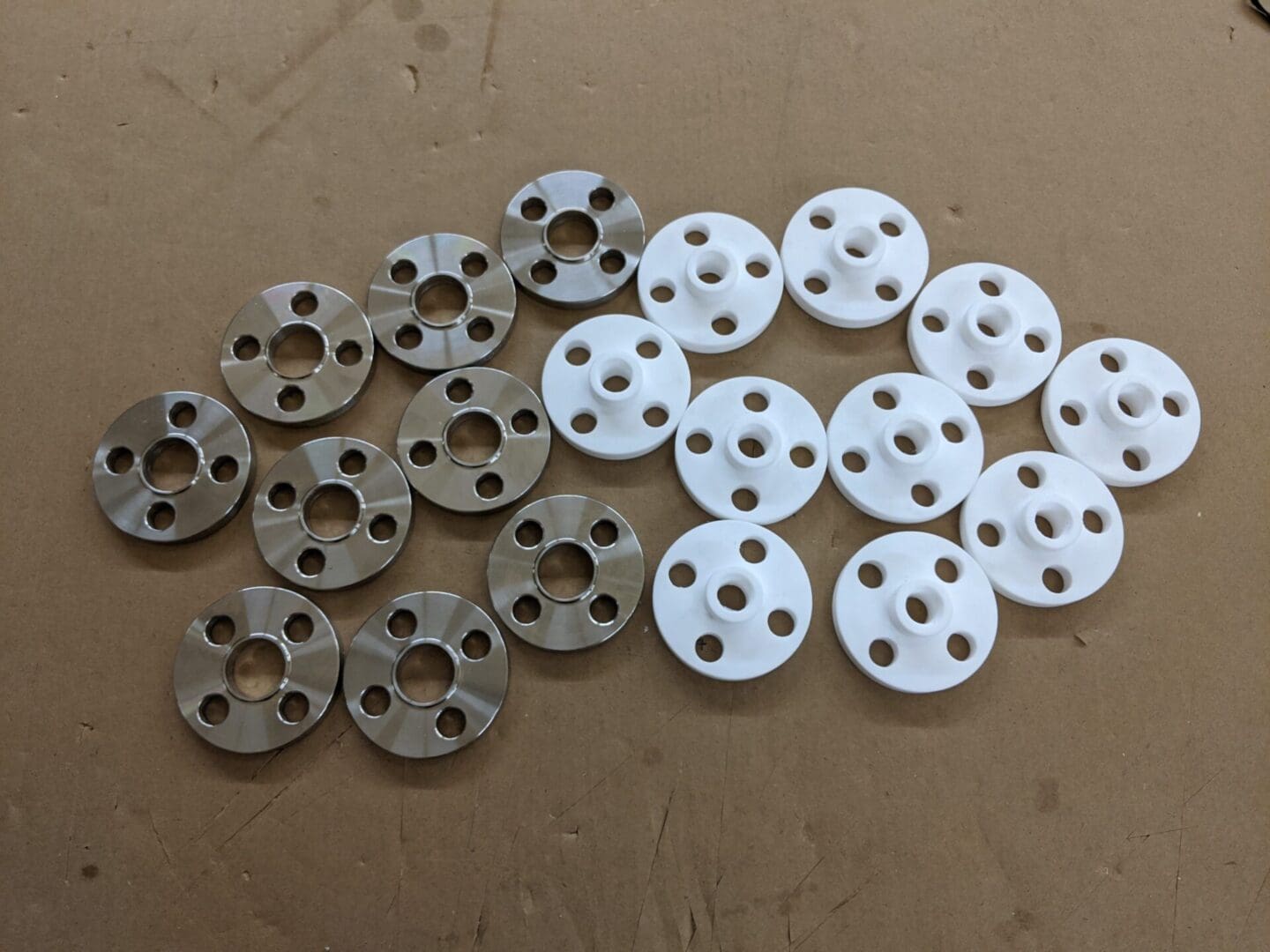 A group of metal discs with holes in them.