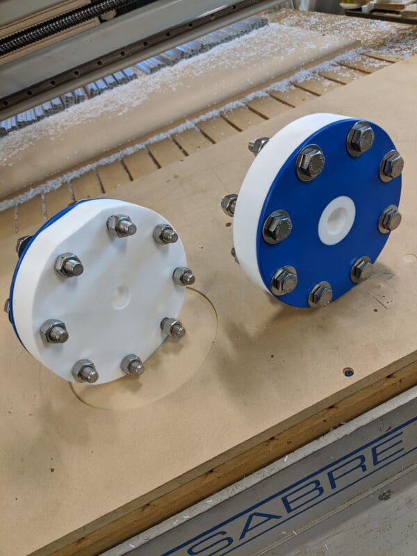 Two large white and blue wheels on a table.