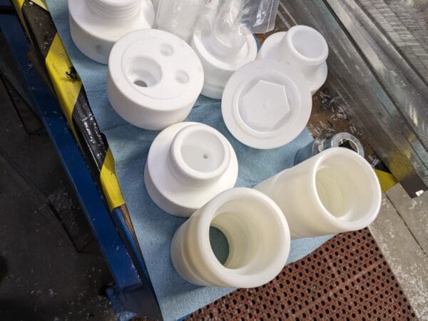 A table with several plastic containers and cups on it.
