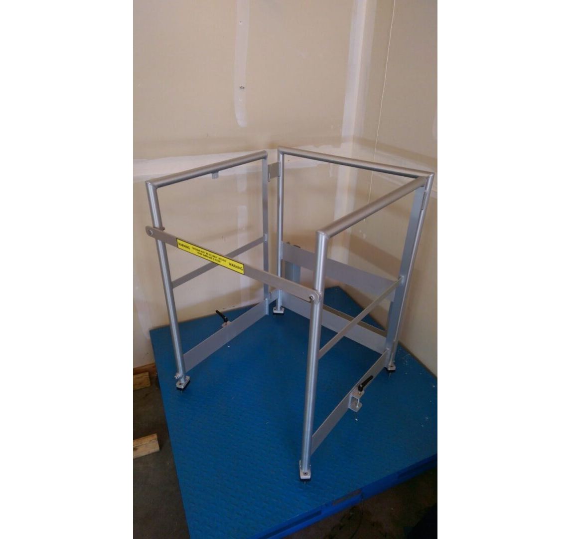 A metal frame with wheels and yellow tape on it.
