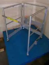 A blue table with a metal frame and yellow tape.