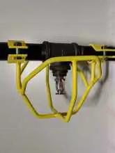 A yellow pipe holder hanging on the wall.