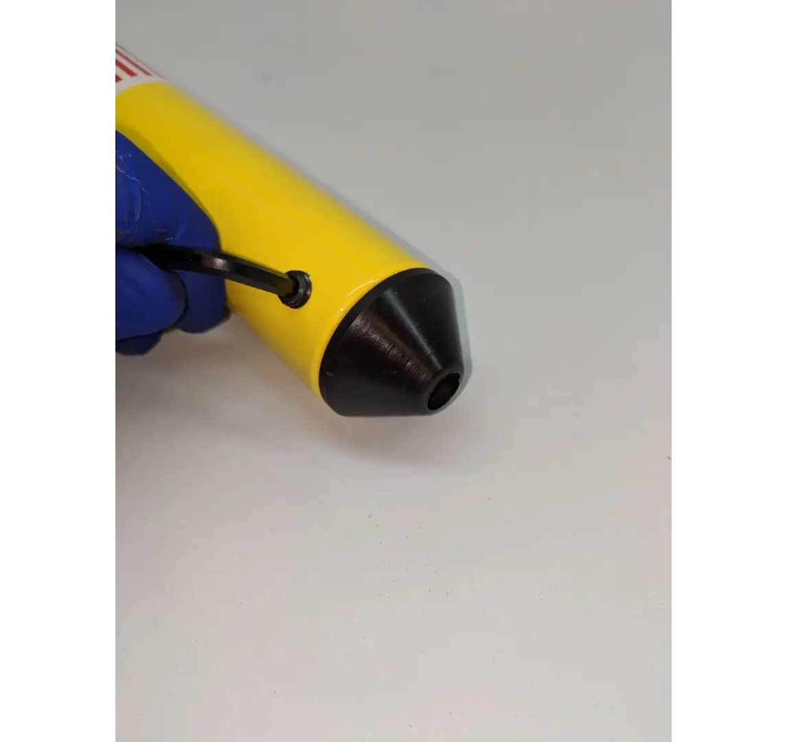 A yellow and black object is being held by a blue tool.